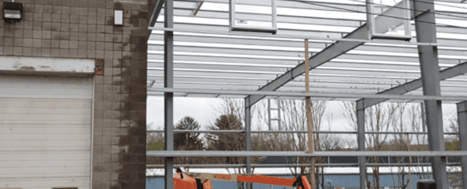 Red Direct steel construction in urban development featuring modern mixed-use buildings within a growing city skyline
