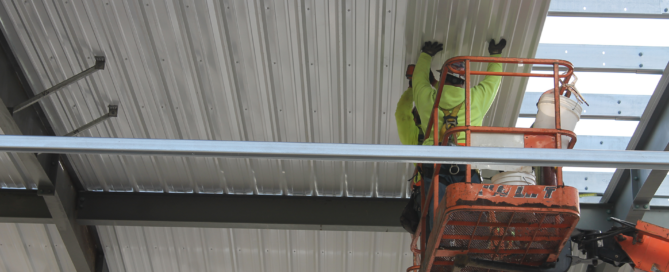 Red Direct custom steel building featuring coordinated exterior finishes, windows, entrances, and operational design options