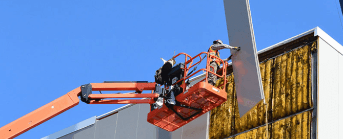 Overhead crane installation inside a pre-engineered industrial steel building with runway beams and structural supports