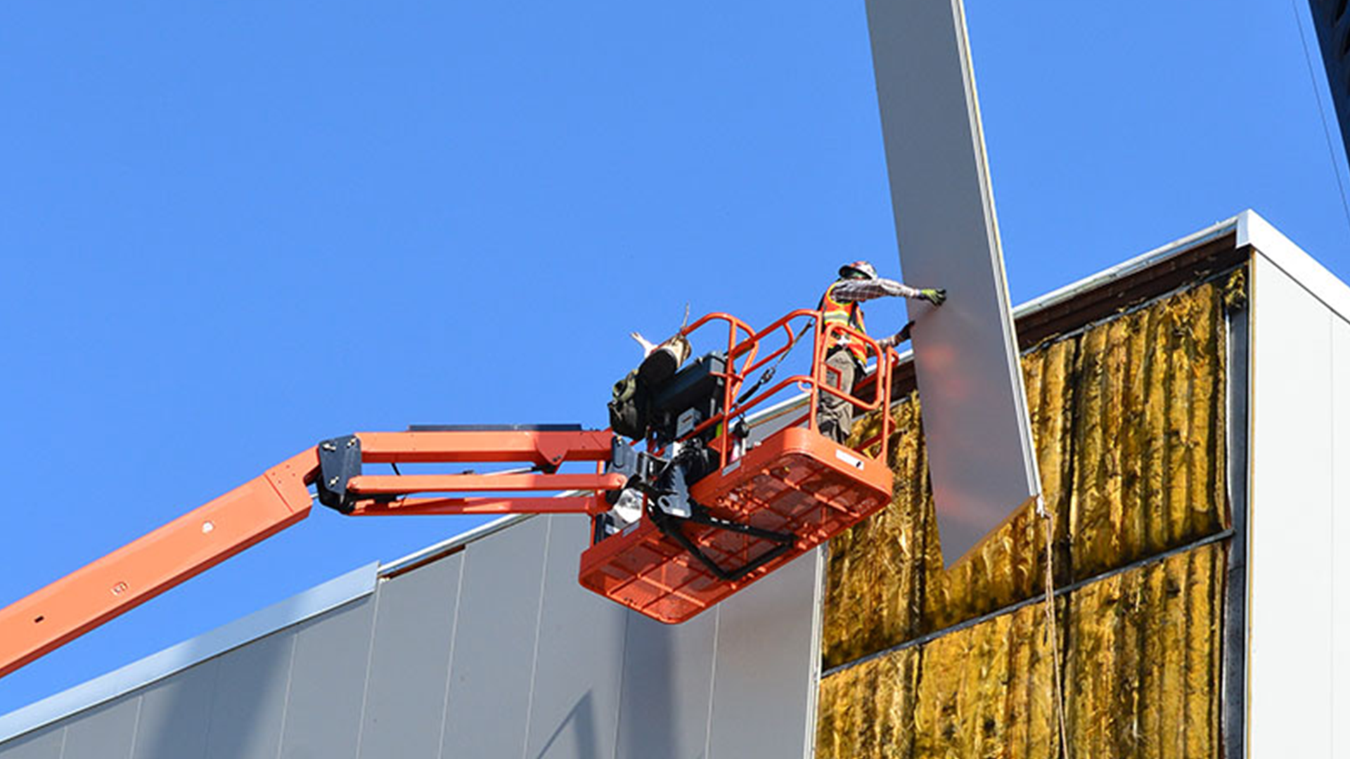 Overhead crane installation inside a pre-engineered industrial steel building with runway beams and structural supports