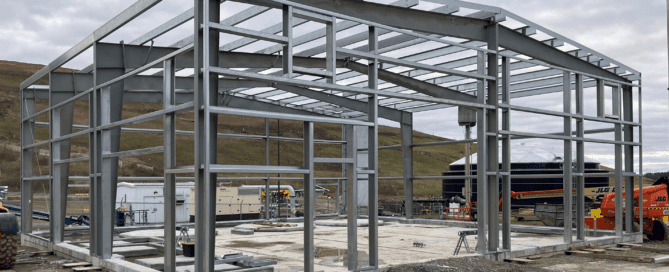 Steel building designed for a natural gas compressor station housing heavy industrial equipment and energy infrastructure systems