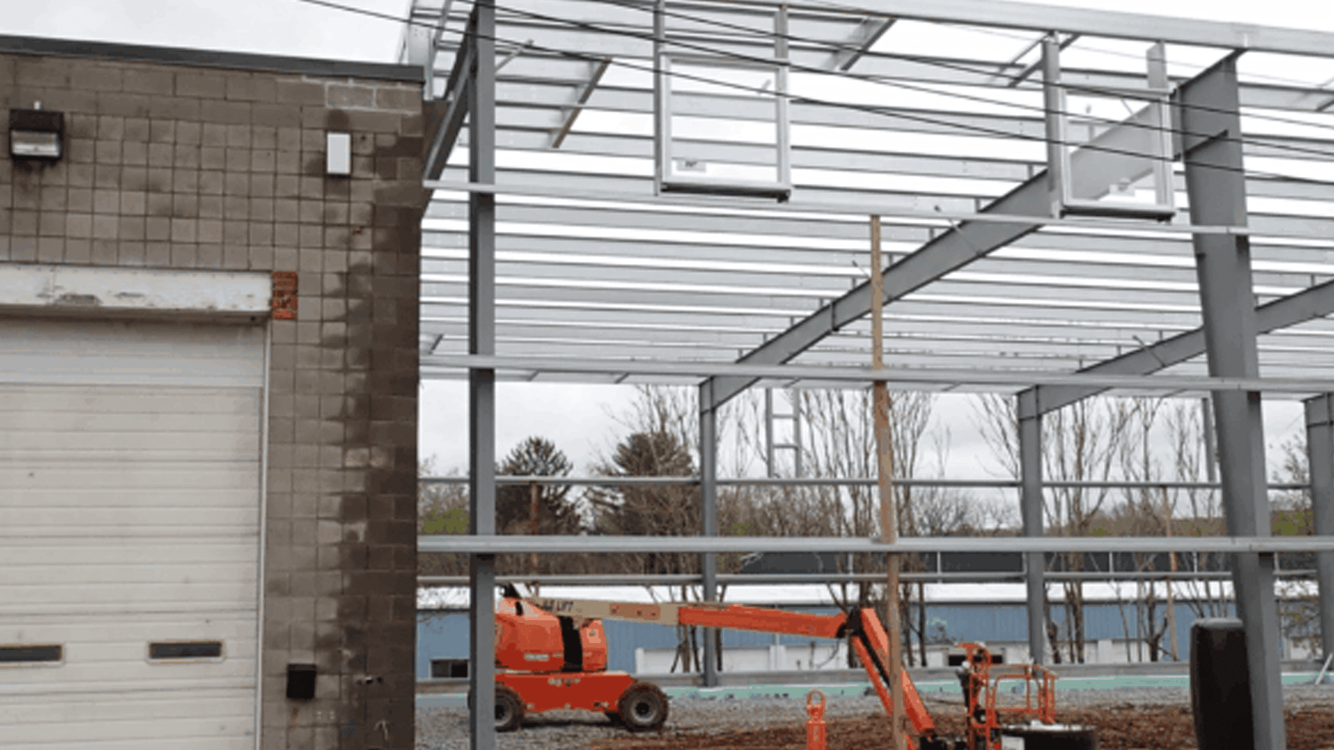Red Direct steel construction in urban development featuring modern mixed-use buildings within a growing city skyline