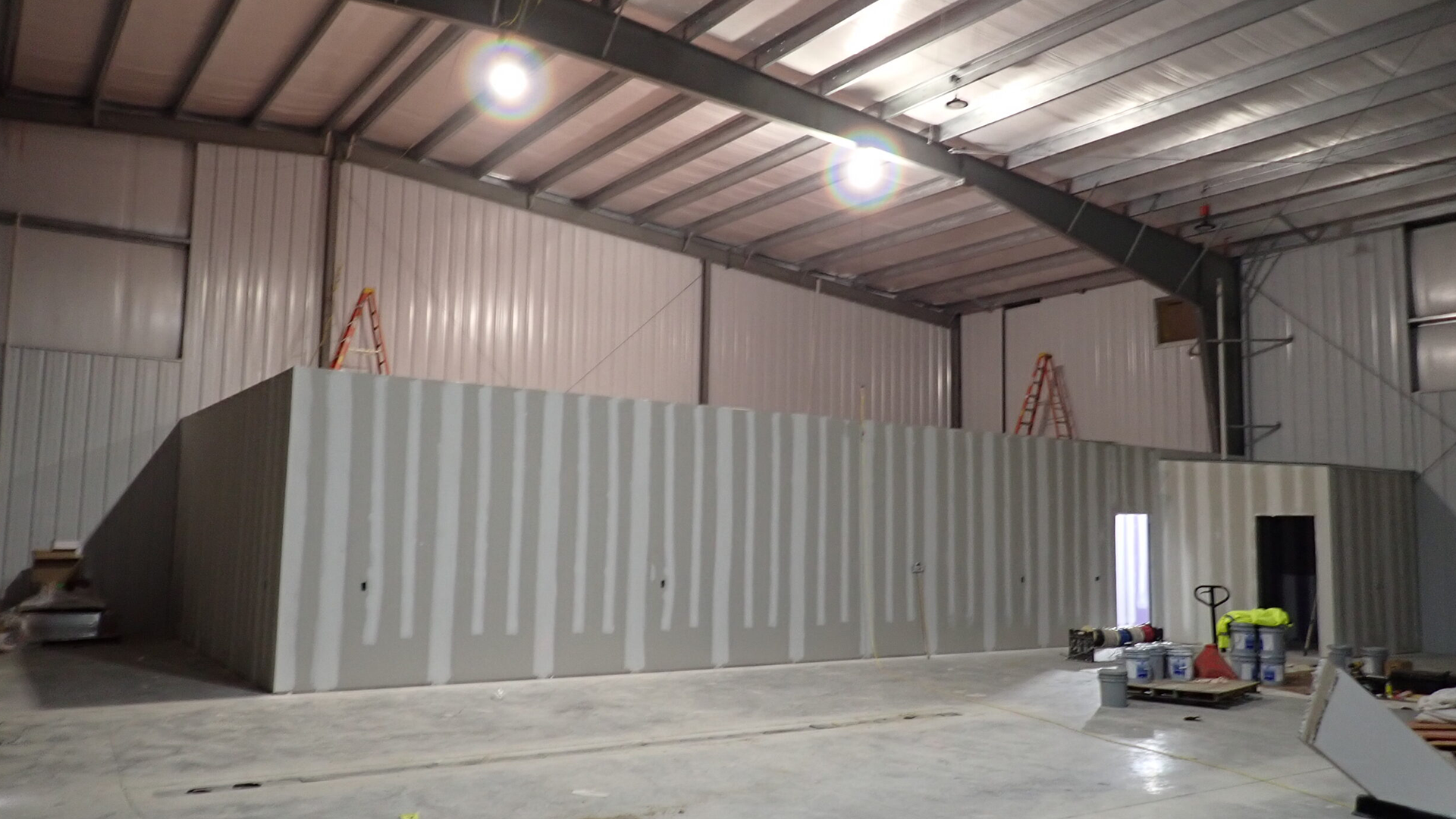 Steel support structures and equipment enclosures on an offshore energy platform in a marine environment.